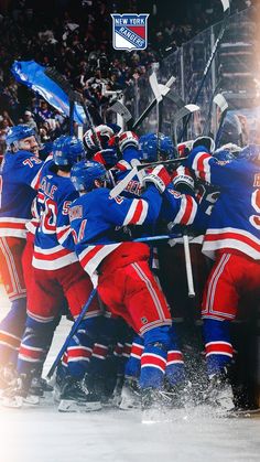 a group of hockey players huddle together on the ice