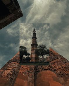 the top of a tall brick building with carvings on it