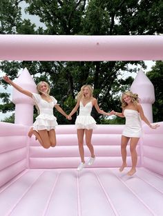 three girls jumping in an inflatable structure