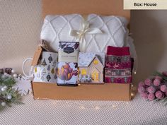 an open box filled with lots of different items on top of a white table cloth