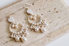 ❄️ Production times have now been extended due to the holidays, please check the estimated delivery date in your cart before ordering. If you need an order sooner than is stated please contact me to see if it will be possible. ❄️ A beautiful pair of bridal earrings made with high quality freshwater pearls in an array of shapes and sizes for a stunning natural look.  The earrings measure approximately 2.5" in length and 1" in width. Please message if you require alternative sizes. The earrings ar Dangle Pearl Drop Earrings, Pearl Chandelier Drop Earrings With Pearl Chain, Pearl Chandelier Earrings For Pierced Ears, Pearl Chandelier Earrings With Pearl Chain For Wedding, Pearl Chandelier Earrings For Wedding, Wedding Chandelier Earrings With Pearl Chain, Pearl Charm Dangle Chandelier Earrings, Dangle Chandelier Earrings With Pearl Charm, Pearl Dangle Chandelier Earrings With Pearl Charm