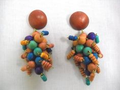 EXOTIC CHUNKY DANGLING EARRINGS - NATURAL WOOD & MULTI COLOR COCO BEAD BOLD STYLE BIG BOHO BROWN MAIN ROUND SECTION with PURPLE - TURQUOISE BLUE - RICH BLUE ROUND WOODEN BEADS & BEADED STICKS OF NATURAL BROWN & COLOR CLUSTER PAIR OF EARRINGS (these are a little bit on the heavy side) Each is approx 3 3/4 inches long & 1 1/4 inches across the cluster (NICE BIG BOLD BOHEMIAN SIZE!) Jewelry for pierced ears - post stick studs butterfly back Please ask any questions before buying Afr Multicolor Beaded Costume Jewelry Earrings, Multicolor Wooden Beaded Earrings, Multicolor Wooden Beads Round Earrings, Multicolor Wooden Beaded Round Earrings, Bohemian Multicolor Beaded Clip-on Earrings, Bohemian Blue Earrings With Wooden Beads, Blue Bohemian Earrings With Wooden Beads, Multicolor Dangle Beaded Earrings With Wooden Beads, Multicolor Wooden Beads Dangle Earrings