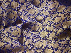 Navy Blue Indian Banaras Brocade Fabric by the Yard Banarasi Blended Silk for Wedding Dress lehenga Skirt Kurta Costume Crafting fabric. This is a beautiful heavy benarse art silk brocade floral design fabric in Navy Blue and Gold. ➤Product: Brocade Fabric ➤Fabric Type: Blended Silk (Viscose and Silk) Fine quality Zari Brocade Weaving from Banaras ➤Color: Blue and Gold ➤Width: 44 inches. ➤Condition: New ➤ Code: bg1036 ➤Listing for 1 Yard of fabric. ➤Care: Dry Clean Only You can use this fabric t Royal Saree With Zari Work, Royal Traditional Wear For Diwali In Traditional Drape, Royal Traditional Wear For Diwali, Royal Traditional Wear For Festive Ceremonies, Blue Jamawar Lehenga For Traditional Ceremonies, Royal Traditional Wear With Pallu For Festive Season, Blue Jamawar Lehenga For Wedding, Royal Gold Traditional Wear With Traditional Drape, Blue Brocade Lehenga For Wedding