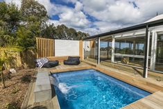 a backyard with a swimming pool and deck