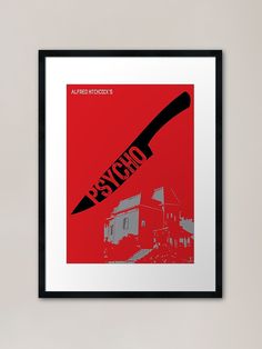 a red poster with a black frame hanging on a wall