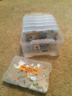 two plastic storage containers filled with assorted items on the floor next to each other