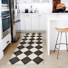 a black and white checkered rug in a kitchen