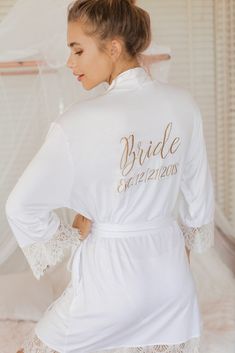 the bride robe is white with gold lettering on it