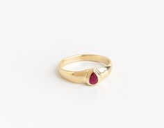 "Beautiful and unique solid gold ring signet ring set with pear-shaped ruby, alternative engagement or wedding ring. This wide 14K yellow gold ring is set with a pear-shaped Deep dark pink Ruby. The ring's wide design and the color of the Ruby give this ring a certain air of majestic and quiet confidence. This ring is comfortable and noticeable and will be great for everyday use, as for a special occasion. It can also be a modern engagement ring. This ring will be a perfect gift for a strong and Yellow Gold Teardrop Jewelry For Proposal, Timeless 14k Gold Teardrop Ring, Fine Jewelry Teardrop Solitaire Ring, Teardrop Yellow Gold Ruby Ring For Wedding, Gold Teardrop Rings For Proposal, Fine Jewelry 14k Gold Pear-shaped Ruby Ring, Classic Teardrop Ruby Ring For Formal Occasions, Modern Yellow Gold Ruby Ring For Wedding, Teardrop Hallmarked Ring For Anniversary