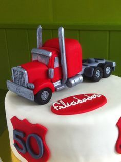 a birthday cake with a red and white truck on it's side that says 50