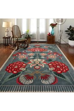 a large rug with red flowers on it