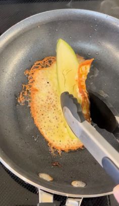 someone is cutting an apple into slices in a frying pan