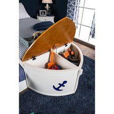 an open storage box with tools inside on carpeted floor next to bed and window