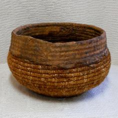 a wooden bowl sitting on top of a white table