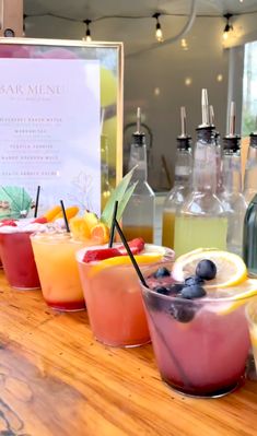 various drinks are lined up on the bar