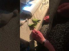 two pictures of someone using a sewing machine to sew something on the floor and another person is holding an object in their hand