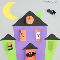 a house made out of paper with bats and ghost on the roof is featured in this halloween craft