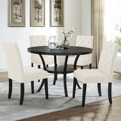 a dining room table and chairs with white upholstered chairs in front of them