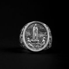 Introducing the Our Lady of Fatima Religious Ring - a stunning piece of jewelry that is handmade from high quality 925 sterling silver. This beautiful ring features a intricate design that is inspired by the famous apparition of Our Lady of Fatima. The ring is crafted with great attention to detail and it is absolutely perfect for any woman who wants to express her faith in a beautiful and unique way. This Our Lady of Fatima Religious Ring makes a wonderful gift for any occasion, or simply as a treat for yourself. It comes presented in a luxurious black velvet pouch, making it perfect for gifting. Whether you are looking for a special gift for someone special, or simply want to treat yourself to something extra special, this Our Lady of Fatima Religious Ring is sure to please. ➤ Item Detai Spiritual Sterling Silver Rings With Engraving Option, Handmade Sterling Silver Signet Ring, Spiritual Silver Ring For Memorial, Spiritual Silver Memorial Ring, Spiritual Sterling Silver Oval Signet Ring, Spiritual Oval Sterling Silver Signet Ring, Oval Sterling Silver Signet Ring Spiritual, Handmade White Gold Sterling Silver Signet Ring, Handmade Spiritual White Gold Signet Ring