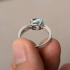 This is a gorgeous handmade creation. Its beauty is its simplicity & Elegance. The 6*8 mm oval shape faceted real Swiss Blue Topaz is crafted in solid sterling silver and with rhodium plated. Main stone weight about 1.47 ct. CZ as accents. All item is sent in a beautiful gift box If you have any idea of design your ring,pls contact me directly. You can realize more lovely stuff clicking the link https://www.etsy.com/shop/knightjewelry?refshopsection_shophome_leftnav Please leave the correct Oval Blue Topaz Ring With Accent Stones, Oval Blue Topaz Ring In Fine Jewelry Style, Oval Blue Topaz Ring Fine Jewelry, Modern Oval Topaz Ring With Prong Setting, Fine Jewelry Oval Blue Topaz Ring, Modern Oval Blue Topaz Ring, Topaz Solitaire Birthstone Ring Oval, Oval Topaz Birthstone Ring In Sterling Silver, Oval Topaz Solitaire Birthstone Ring