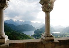 two stone pillars overlooking a lake and mountains