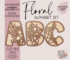 the wooden alphabet set is shown with flowers and leaves on it's letters, which are