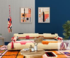 a living room filled with furniture and colorful rugs on top of a wooden table