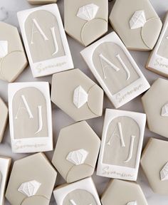 some cookies with white icing on top of each one and the letters a to z