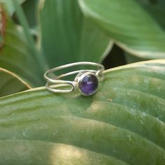 This purple amethyst ring is designed and crafted for everyday wear. This ring is understated yet elegant, and the double-band makes it more of a statement piece. Wear stacked with other rings or on its own. The ring fits as a size 6. Sterling silver may tarnish over time but can be very easily shined with a polishing cloth or silver cleaning solution to keep it looking brand new.  Follow me on Instagram for more @wildcarrotjewelry Purple Sterling Silver Minimalist Jewelry, Purple Sterling Silver Birthstone Ring, Minimalist Amethyst Gemstone Ring, Purple Sterling Silver Birthstone Ring With Round Stone, Dainty Amethyst Gemstone Stackable Rings, Purple Amethyst Open Ring Birthstone, Dainty Amethyst Stackable Rings, Purple Amethyst Birthstone Open Ring, Minimalist Purple Sterling Silver Jewelry