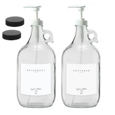 two bottles with soap dispensers next to each other on a white background