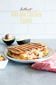 an avocado chicken panini on a white plate next to some guacamole