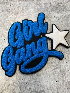 a blue and white sticker that says girl gang on it with a star next to it