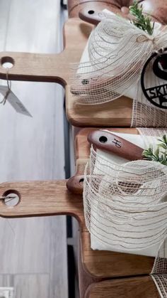 two wooden cutting boards with scissors and some string wrapped around the handles on each one