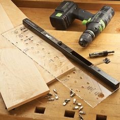 tools are sitting on top of a wooden table next to screwdrivers and nails