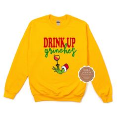 Shop our super cute Drink up Grinches Christmas Shirt today. This Grinch Christmas Shirt is sure to be a hit at your Christmas Party. This Funny Grinch Sweater is unisex and available in sizes S-4X.Get either your normal size (for a loose fit) or size down for a more fitted look.(e.g., if you are a Ladies XL, choose Unisex L)*** UNISEX FIT offers a relaxed fit that works well for men and women. Sweatshirt -50% ring-spun cotton/50% polyester; -Soft fleece inside -Mid-weight, Boyfriend/unisex fit Fun Winter T-shirt With Crew Neck, Funny Crew Neck T-shirt For Winter, Funny Crew Neck Tops For Winter, Novelty Christmas Crew Neck Top, Christmas Novelty Crew Neck Tops, Novelty Crew Neck Tops For Christmas, Fun Crew Neck T-shirt For Winter, Funny Print Sweatshirt For Winter, Fun Winter Crew Neck T-shirt