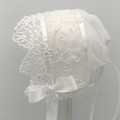 This pretty bonnet is perfect for all of baby's formal events.  It is made with two layers of sheer fabric, edged with a heart motif lace.  There is a ribbon adjustable back closure and satin ribbon ties.   3-6m      16-18" 9-12m    18-20" Hand wash, line dry, cool iron (use a press cloth) All components are CPSIA compliant. All items are made in a smoke and pet free environment. Lace Bonnet, Baby Girls Dresses, Heart Motif, Sheer Fabric, Lace Flowers, Ribbon Tie, Silver Accents, Sheer Fabrics