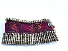 This vintage beautiful handmade anklet originates from Nuristan ( Nooristan), Afghanistan , and has been traditionally worn by women of the region . This Afghan anklet features of 57 alloy metal beads at the top side of a band and 58 Silver strip beads each measuring 3cm in length, along the bottom side. The anklet measures 26cm in length and 6.5cm width,with a two button closure. The anklet itself has a beautiful stunning design. .Material: Alloy metal beads Silver strip beads Fabric  .Number of beads:  Silver 58 ( each measuring 3cm in length) Alloy metal beads 57 .Dimensions : Length: 26cm Width: 6.5cm .Condition: The anklet is in good vintage condition, with minimal signs of wear . Nooristan Afghanistan, Beads Fabric, Handmade Anklets, Afghan Jewelry, Fabric Beads, Anklet Jewelry, Body Jewellery, Metal Beads, Silver Beads