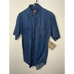 This C E Schmidt Workwear Men’s Button-Down Shirt Is A Must-Have For Your Work Wardrobe. Men Small ,20 Inches Pit To Pit And 27 Inches Shoulder To Waist . The Shirt Features A Solid Pattern, Long Sleeves, And A Collared Neckline With A Button-Down Closure. Made With 100% Cotton Denim Fabric, This Shirt Is Comfortable And Durable For Everyday Wear. The Shirt Is Accented With Buttons And Comes In A Vintage Blue Color. It Has Easy Care And Pockets Features, Making It Practical For Workwear. Availab Denim Blue Chambray Shirt With Button Closure, Washed Blue Chambray Shirt With Buttons, Washed Blue Denim Short Sleeve Top With Buttons, Washed Blue Short Sleeve Denim Top With Buttons, Washed Blue Denim Top With Buttons And Short Sleeves, Denim Blue Short Sleeve Top With Buttons, Fitted Chambray Shirt With Button Closure, Medium Wash Denim Shirt With Button Closure, Medium Wash Denim Top With Short Sleeves