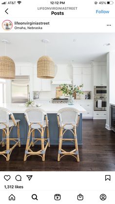 three wicker bar stools sit in the middle of a kitchen with white cabinets