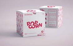 two white boxes with pink and red designs on them, one is for pop corn