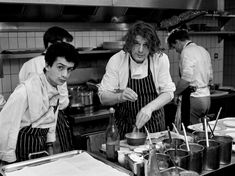 black and white photograph of three men working in a kitchen