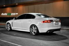 a white car parked in front of a building