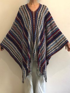 Oh man, I love Missoni!  Gorgeous Y2K zig zag wool and acrylic Missoni fringe poncho top.  Iconic zig zag pattern.  Open lattice work in the knit pattern - great texture.  Such a good boho vibe. Knit is made from wool and acrylic.  Classic zig zag pattern in pale pink, grey, blue and red - no one color mixes like Missoni! They are the best.  Can be worn as a stand alone top or poncho over whatever you like.  Medium weigh knit.  Fringe at the edges. Label Missoni, 50% wool, 50% acrylic, Dry clean only.  Good vintage condition, no pilling the wool feels good and strong.  Measurements  Shoulder to sleeve - 57cm/ 22inches Shoulder to hem 70cm/ 27inches Models Measurements Shoulders 42cm/ 16.5inches Chest 84cm/ 33inches Waist 66cm/ 26inches Hips 92cm/ 36inches Height 175cm/ 5'9'' Multicolor Bohemian Wool Poncho, Kids Kimono, Knit Fringe, Boho Pullover, Fringe Poncho, Poncho Top, Flower Scarf, Boho Sweater, Fringed Poncho