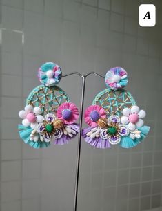 Handmade Statement Floral Pink-Purple - Blue Hoop Earrings. These stunningly beautiful, purely handmade and handcrafted,intricate earrings are made using raffia, handmade flowers, fabric pompoms, glass beads, and a lot more. The earrings have unique intricate workmanship and undoubtedly beautiful. The earrings are ideal for day parties or just wear them as you want.. The earrings measure approx. 3.20" long and 2.60" wide. Available in two color options: A and B At Carnation jewellery, each piece is artisan handcrafted with love and care and shipped from India.  * SHIPPING - Please refer to the "announcement" page of the store. * Please be noted all kind of taxes, custom duties, VAT etc will be borne by the buyer as I am not responsible for the same. * For queries, please reach out to me an Bohemian Flower Earrings For Vacation, Handmade Multicolor Earrings For Spring, Bohemian Spring Hoop Earrings For Party, Handmade Multicolor Flower Earrings For Spring, Pink Hoop Earrings For The Beach, Handmade Bohemian Flower Earrings For Vacation, Handmade Earrings For Spring Party, Bohemian Earrings For Spring Party, Bohemian Spring Earrings For Party