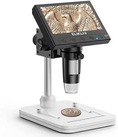 an image of a microscope on a tabletop with the camera attached to it's stand