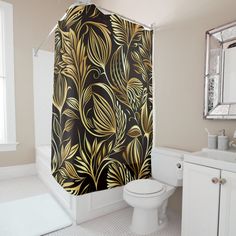 a bathroom with a black and gold shower curtain next to a white toilet in front of a window