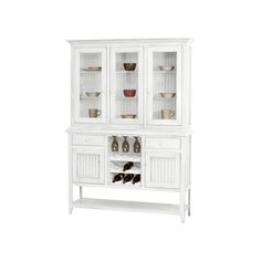 a white china cabinet with glass doors and shelves