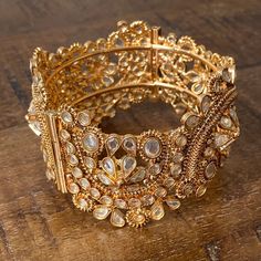 Vintage Traditional Indian Gold Toned Cuff Bracelet with Glass Crystals and Floral Motifs Secure Closing Beautiful vintage gold toned cuff bangle bracelet with screw secure closing. Floral motifs with embedded crystals. Great vintage condition.Measurements Width: 3.5cm/1.4”Diameter: 6cm/2.4” Vintage Traditional, Shell Ring, Cuff Bangle Bracelet, Carved Shell, Trade Beads, Beaded Tassels, Traditional Indian, Cuff Bangles, Floral Motifs