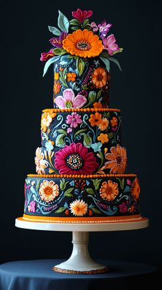 a multi - tiered cake decorated with colorful flowers