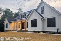 a white house with black shutters on the front and windows in the back yard